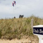 Utah Beach with sign and monument.
